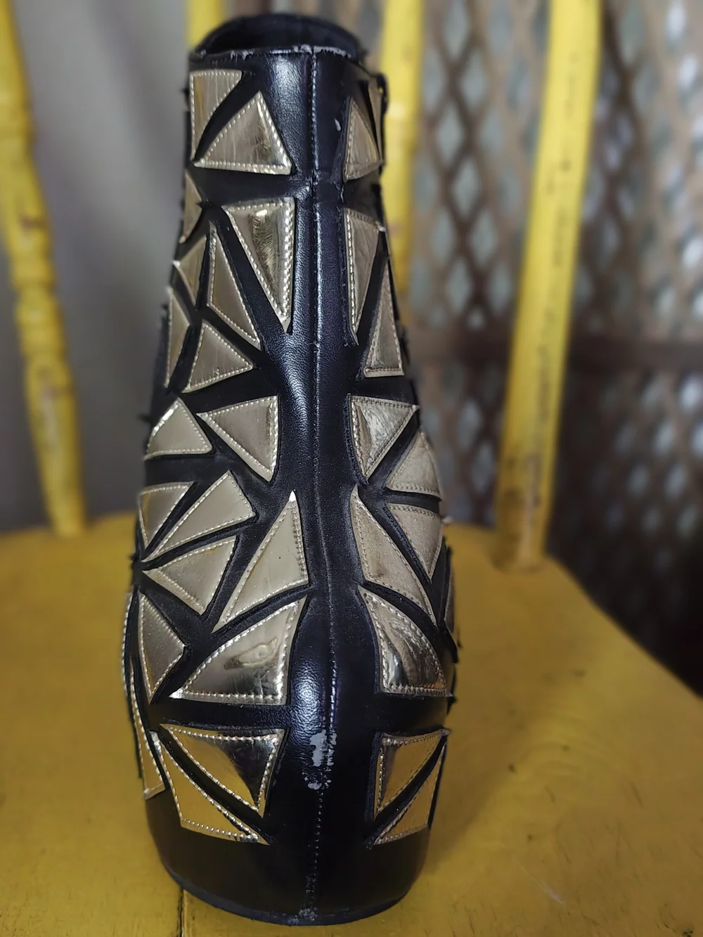 Prestiged Women's Black Ankle Wedge Booties with Gold Geometric Accents